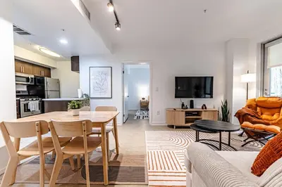 a kitchen and living room with a table and chairs at Stylish 2BDR & 2BTH - 15 mins walk to the beach! in Los Angeles