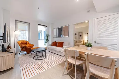 a living room with a table and a couch at Stylish 2BDR & 2BTH - 15 mins walk to the beach! in Los Angeles