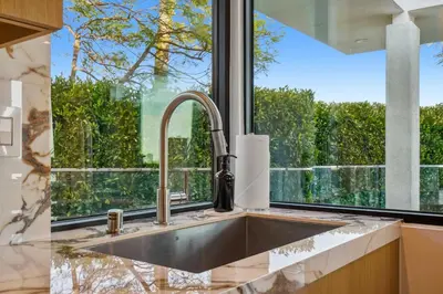 a kitchen sink with a large window above it at The Elvis Villa by Stay Awhile Villas in Los Angeles