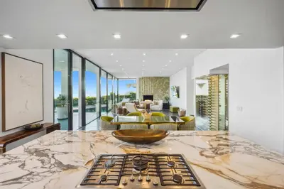 a kitchen with a marble counter top and a living room at The Elvis Villa by Stay Awhile Villas in Los Angeles