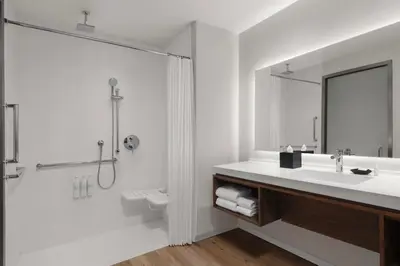 a bathroom with a sink and a shower at AC Hotel by Marriott Pasadena in Pasadena