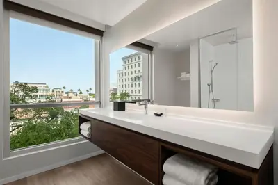 a bathroom with a sink and a large window at AC Hotel by Marriott Pasadena in Pasadena