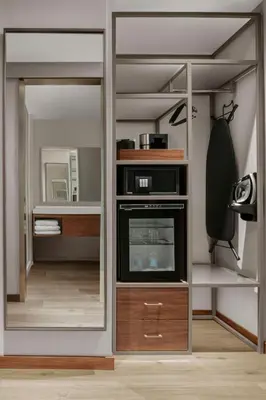 a closet with a mirror and a tv in it at AC Hotel by Marriott Pasadena in Pasadena