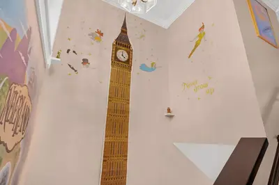 a wall with big ben in a room with a clock at Disneyland Oasis by OC Adventure Homes in Cypress