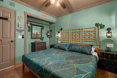 a bedroom with a bed with a wooden head board at Disneyland Oasis by OC Adventure Homes in Cypress