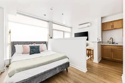 a bedroom with a bed and a kitchen at Amazing studio in SM Promenade! Free parking! in Los Angeles