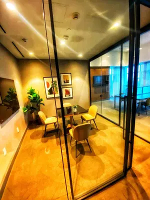 a room with a table and chairs and a glass wall at Elegant Luxury 1 Bedroom studio in Downtown LA in Vernon