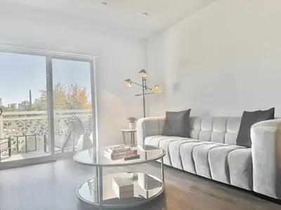 a living room with a couch and a glass table at Silver Lake Stylish Penthouse One Bdrm with Parking included in Los Angeles