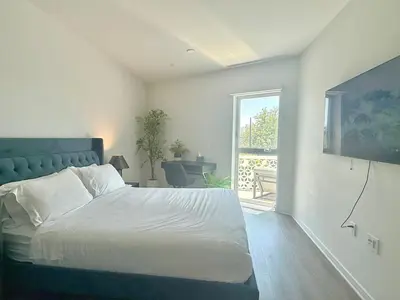 a bedroom with a large bed and a window at Silver Lake Stylish Penthouse One Bdrm with Parking included in Los Angeles