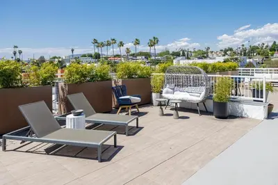 a patio with chairs and furniture on a roof at Silver Lake Stylish Penthouse One Bdrm with Parking included in Los Angeles
