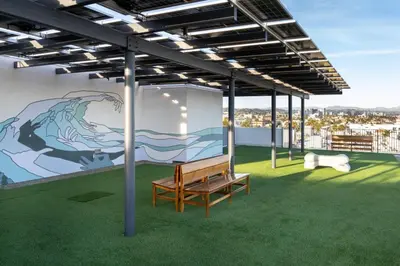 a bench in a room with a mural on the wall at The Pearl Coast - Rooftop Pool, Gym Luxurious 2BR Santa Monica in Los Angeles