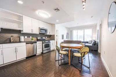 a kitchen and living room with a table and chairs at Spacious 2BD 2BA with Huge Balcony, Near Venice Beach & Fun! in Marina del Rey