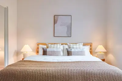 a bedroom with a large bed with two lamps at Well-Located 3BR Near SoFi Stadium & LAX in Los Angeles
