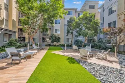 a courtyard with chairs and grass in a building at Well-Located 3BR Near SoFi Stadium & LAX in Los Angeles