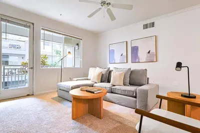 a living room with a couch and a table at Well-Located 3BR Near SoFi Stadium & LAX in Los Angeles