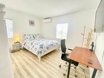 a bedroom with a bed and a desk in it at Sunset room only 1 guest near DTLA in San Gabriel