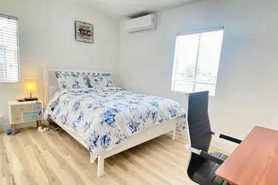 a bedroom with a bed and a desk and a window at Sunset room only 1 guest near DTLA in San Gabriel