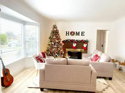 a living room with a christmas tree in front of a fireplace at Sunset room only 1 guest near DTLA in San Gabriel