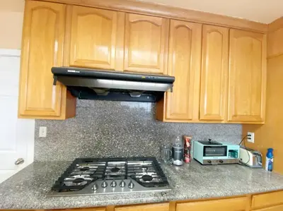 a kitchen with a stove top and a microwave at Sunset room only 1 guest near DTLA in San Gabriel