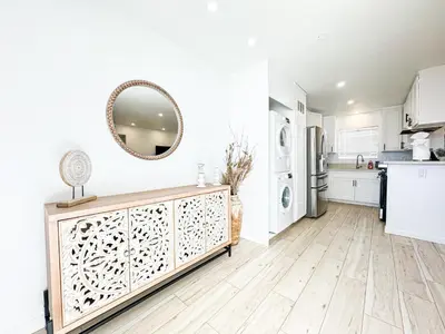 a kitchen with white cabinets and a mirror on the wall at Boho-Chic 1BR-1BA Oasis near Hollywood -BRBEV13 in Los Angeles