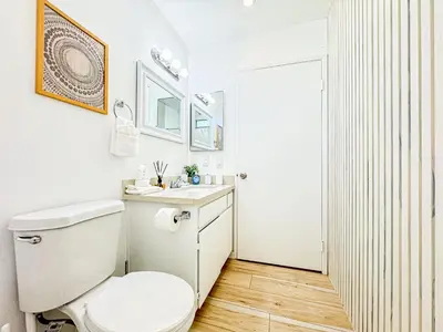 a white bathroom with a toilet and a sink at Boho-Chic 1BR-1BA Oasis near Hollywood -BRBEV13 in Los Angeles