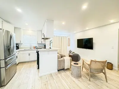 a kitchen and living room with white cabinets at Boho-Chic 1BR-1BA Oasis near Hollywood -BRBEV13 in Los Angeles