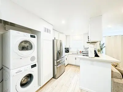 a white kitchen with a washer and dryer at Boho-Chic 1BR-1BA Oasis near Hollywood -BRBEV13 in Los Angeles