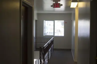 an empty hallway with a window and a stair case at Lido Hotel in Huntington Park