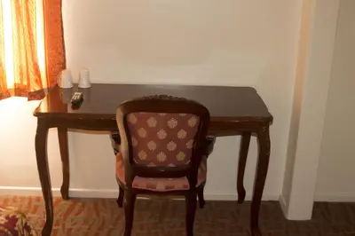 a wooden desk with a chair in a room at Lido Hotel in Huntington Park