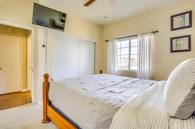 a bedroom with a bed and a tv and a window at Family-Friendly Home with Fenced Yard in Victorville in Victorville