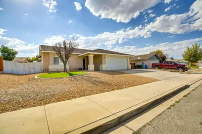 a house with a truck parked in a driveway at Family-Friendly Home with Fenced Yard in Victorville in Victorville