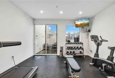 a fitness room with a gym with tread machines at Iconic Heart of DTLA Loft with Rooftop Pool Jacuzzi Gym in Los Angeles