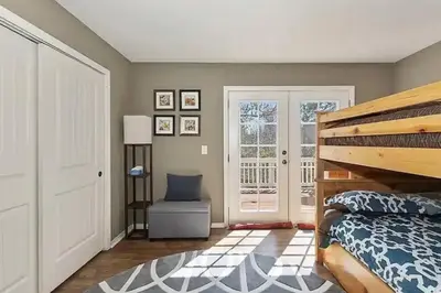 a bedroom with a bed and a sliding glass door at Whispering Pines A-Frame, Pool Table, 2 Patios! in Lake Arrowhead