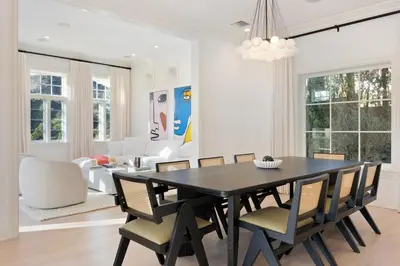 a dining room with a black table and chairs at Chateau Beverly Hills by Stay Awhile Villas in Los Angeles