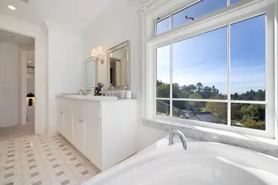 a white bathroom with a tub and a window at Chateau Beverly Hills by Stay Awhile Villas in Los Angeles