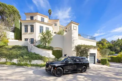 a black limousine parked in front of a house at Chateau Beverly Hills by Stay Awhile Villas in Los Angeles