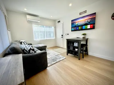 a living room with a couch and a flat screen tv at RP415B - Inviting 1-Bedroom Haven in Captivating Burbank in Burbank