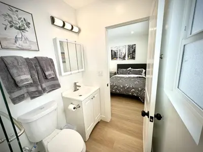 a bathroom with a toilet and a sink and a bed at RP415B - Inviting 1-Bedroom Haven in Captivating Burbank in Burbank
