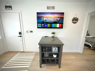 a room with a table and a tv on the wall at RP415B - Inviting 1-Bedroom Haven in Captivating Burbank in Burbank
