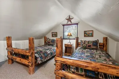 a bedroom with two beds in a attic at Smo Haus- Located in the quiet area of Big Bear City, with mountain views. in Big Bear City