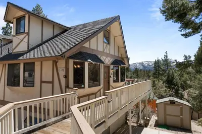 a house with a wrap around porch with a deck at Smo Haus- Located in the quiet area of Big Bear City, with mountain views. in Big Bear City