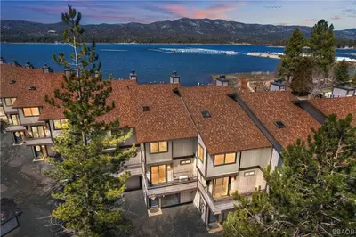 an aerial view of a house with a lake at Shores Lakefront Condo - Walk to Village, Lake Views, Deck with BBQ in Big Bear Lake