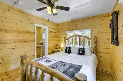 a bedroom with a bed in a log cabin at Walk to Water Cozy Cabin in Green Valley Lake! in Green Valley Lake