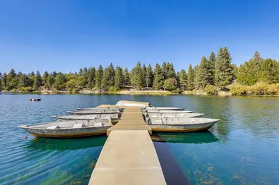 a row of boats tied to a dock on a lake at Walk to Water Cozy Cabin in Green Valley Lake! in Green Valley Lake