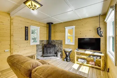 a living room with a couch and a fireplace at Walk to Water Cozy Cabin in Green Valley Lake! in Green Valley Lake