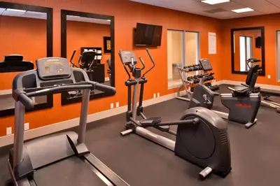 a gym with several cardio machines in a room at Holiday Inn Express Hotels & Suites Loma Linda by IHG in Loma Linda