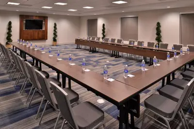 a long table in a room with chairs at Holiday Inn Express Hotels & Suites Loma Linda by IHG in Loma Linda