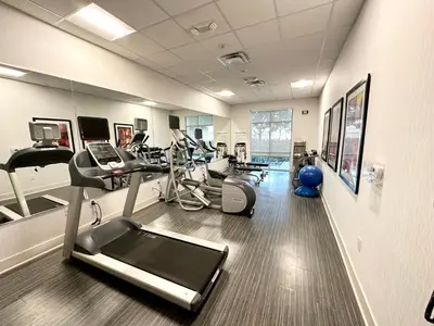 a gym with several exercise bikes and a treadmill at Holiday Inn Express & Suites Anaheim Resort Area by IHG in Anaheim