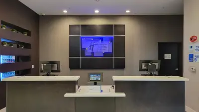 a waiting room with a tv on the wall at Holiday Inn Express & Suites Anaheim Resort Area by IHG in Anaheim