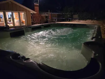 a large pool of water in a yard at night at Westside Retreat w Yard, Grill, Hot Tub, Near Sofi Stadium, LAX, and the Beach in Los Angeles